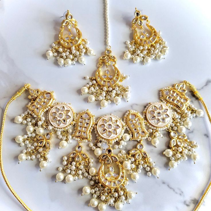 Gorgeous kundan and meenakari bridal set with earrings, teeka and jhoomer. Affordable Meenakari Jewelry For Puja, Wedding Bridal Sets With Meenakari, Chandbali Kundan Tikka With Mirror Work, Traditional Meenakari Chandbali Sets, Bollywood Kundan Chandbali Sets, Traditional Wedding Jewelry Sets With Gota Work, White Kundan Anarkali Set For Eid, Eid Kundan Tikka With Stone Work, White Bridal Sets For Eid Festive Occasion