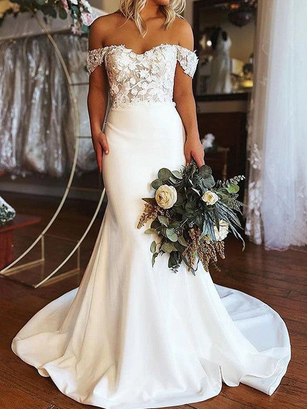 a woman in a wedding dress holding a bouquet