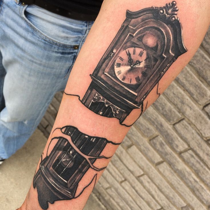 a man with a clock tattoo on his arm