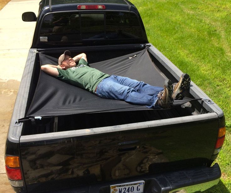 a man laying in the bed of a truck