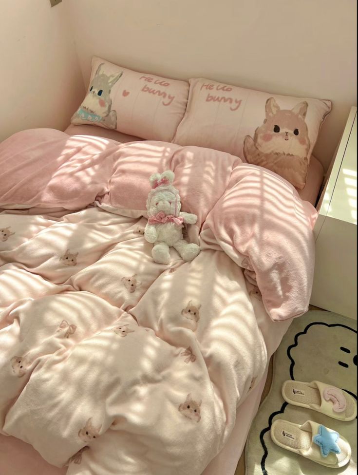 there is a bed with pink sheets and pillows