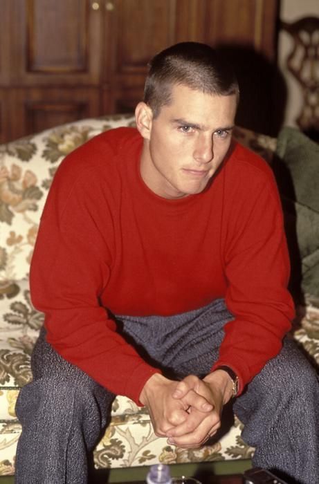 a young man sitting on top of a couch