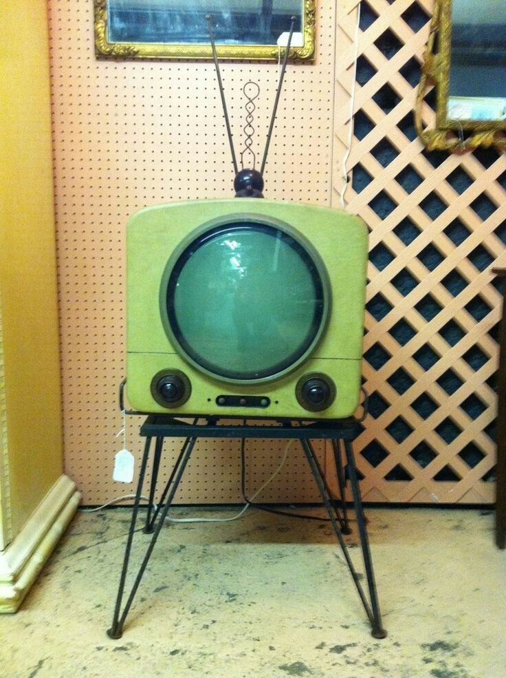 an old fashioned television sitting on top of a stand