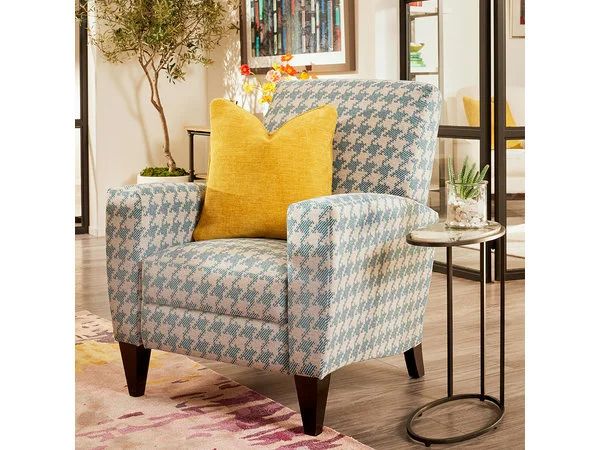 a blue and white chair sitting on top of a wooden floor