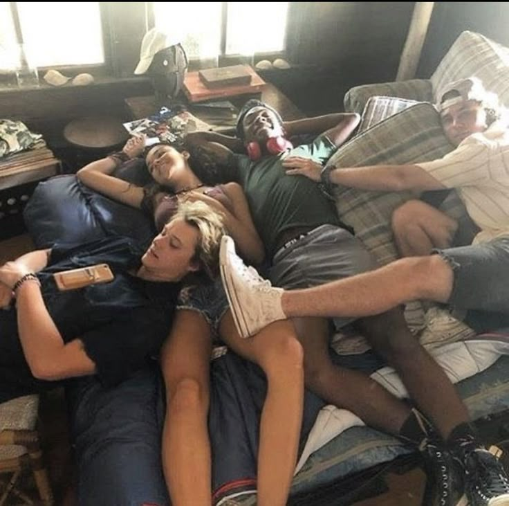 several people laying on top of each other in a living room