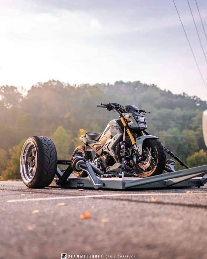 a motorcycle is parked on the side of the road with it's wheels still attached