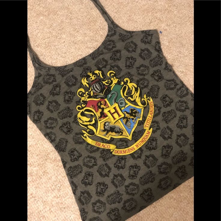 a hogwarts house logo on the back of a harry potter tank top that is laying on the floor