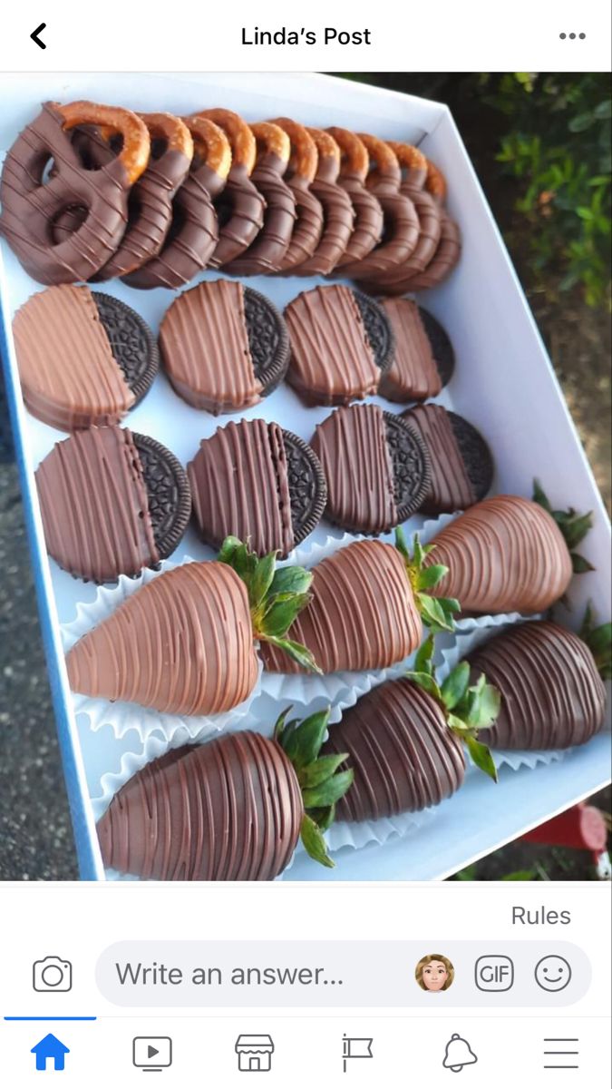 a box filled with chocolate covered cookies and strawberries next to an instagram post