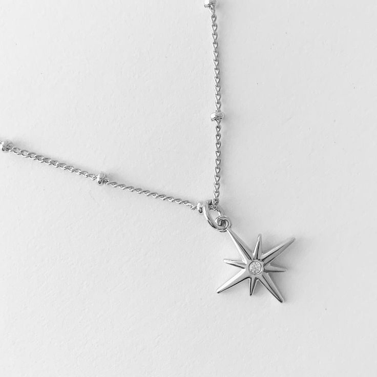 A beaded satellite chain featuring a suspended celestial starburst charm dotted with a tiny crystal in its center. Wear this alongside your favorite necklace for instant layering perfection. Length: adjustable between 20" - 24". Charm: 14mm. Our materials make for an amazing, high quality, seamless, jewelry piece with longevity. Our necklaces are plated with 18k gold, 18k rose gold, or rhodium and finished with a protective coating. A little secret we’ll keep between us: it looks way more than i Adjustable Celestial Necklace With Star Charm, Dainty Adjustable Star Charm Necklace, Adjustable Star-shaped Necklace With Delicate Chain, Dainty Adjustable Star Charm Necklaces, Celestial Starburst Necklace With Star Charm, Adjustable Star Shaped Charm Necklace With Adjustable Chain, Everyday Star Necklace With Adjustable Chain, Everyday Celestial Necklace With Star Charm, Everyday Celestial Star Necklace