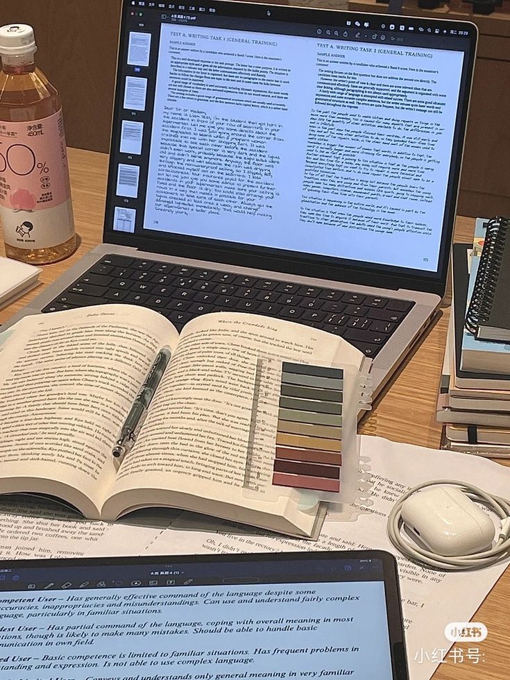 an open book sitting on top of a laptop computer