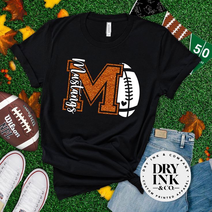 a football with the letter m on it next to other sports items