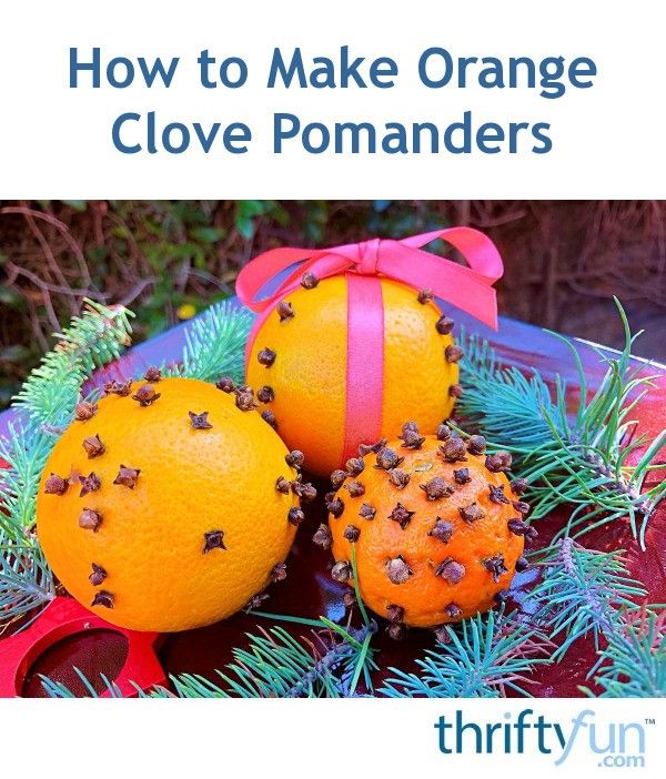 two oranges with bows on them sitting next to pine cones and evergreen branches in front of the words how to make orange clove pomanders