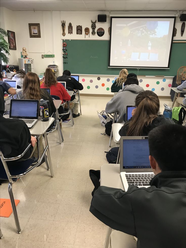 a classroom full of students with laptops