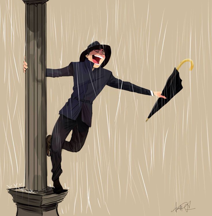 a man holding an umbrella while standing on top of a pole