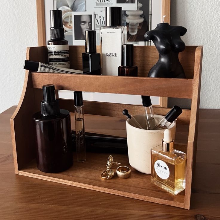 a wooden shelf filled with cosmetics and personal care items on top of a wooden table