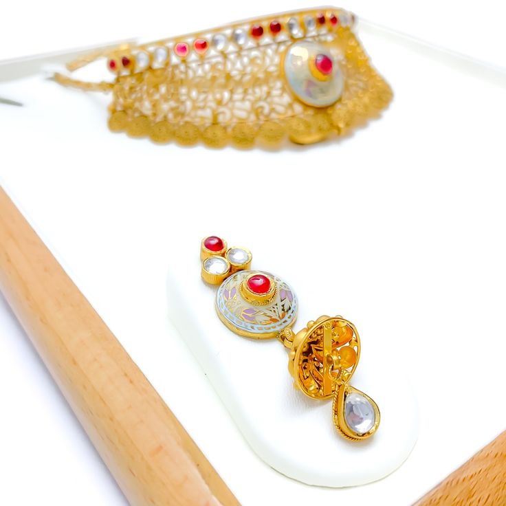 Experience sheer elegance with our Exclusive Enameled Kundan Choker Set, boasting exquisite Kundan stones and crafted with 22k antique gold weighing 63.7 grams. This opulent set features an adjustable length of 14" with 1" links and a secure hook lock. The stunning choker has a width of 1.75" and a drop length of 0.75". It also includes matching earrings, 2.3" in length with screw backs. Make a bold statement with this unique and timeless piece, finished with a regal antique gold shine. PRODUCT Gold Dual-tone Chandbali Kundan Necklace, Gold Hallmarked Kundan Necklace For Diwali, Gold Dual-tone Jewelry Sets As Gift, Dual-tone Gold Jewelry Sets For Gifts, Ceremonial 22k Gold Meenakari Jewelry, Gold Meenakari Temple Jewelry Sets, Gold Dual-tone Bridal Necklace For Festive Occasions, Festive Dual-tone Gold Plated Jewelry, Dual-tone 22k Gold Jewelry Gift