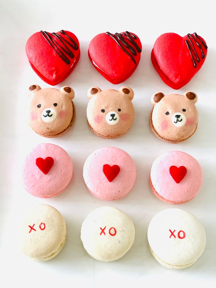 valentine's day cupcakes with teddy bears and heart shaped cookies on them