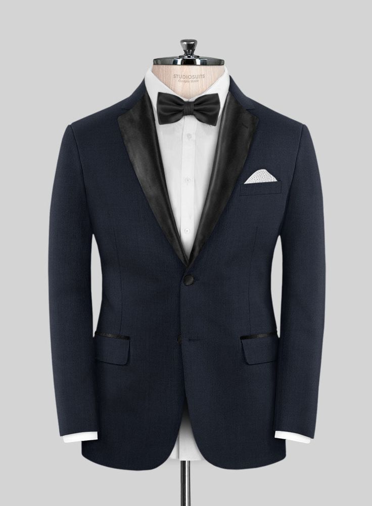 Set your style ablaze with the irresistible allure of the Napoleon Dark Blue Wool Tuxedo Suit. Meticulously crafted from the finest premium wool, this tuxedo features a deep, rich blue hue that adds a subtle yet striking visual appeal to your ensemble. Whether you're attending a black-tie gala, a luxury wedding, or a formal evening soirée, the Napoleon Dark Blue Wool Tuxedo Suit is your ticket to commanding attention and making an unforgettable impression.  Featuring satin lapel, matching satin Custom Fit Tuxedo Suits For Tailoring, Bespoke Fitted Single-breasted Tuxedo, Bespoke Tailored Blue Tuxedo, Bespoke Blue Tuxedo, Tailored Fitted Tuxedo With Suit Collar, Fitted Tuxedo With Hidden Button Closure For Parties, Luxury Fitted Tuxedo With Hidden Button Closure, Single Breasted Tuxedo For Wedding, Bespoke Tuxedo With Notch Lapel Custom Fit