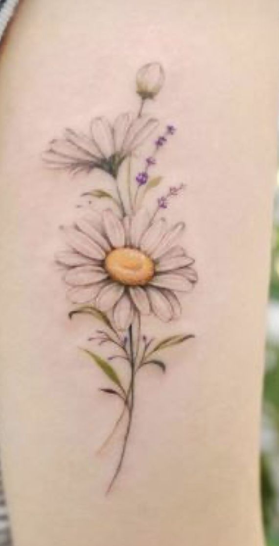 a drawing of a flower on the back of a woman's thigh