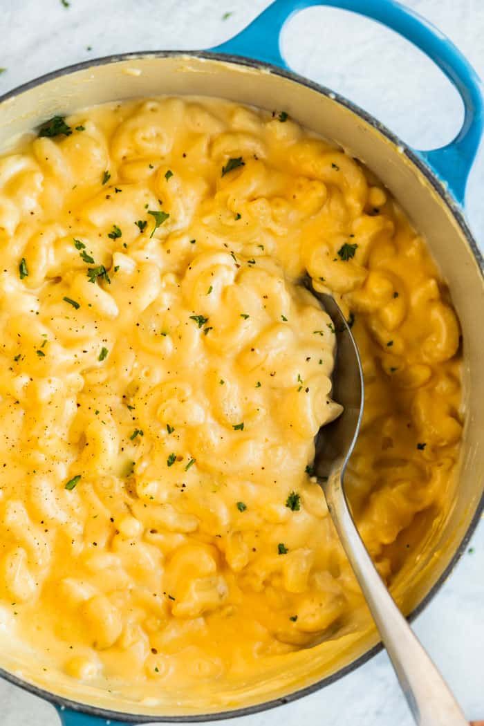 macaroni and cheese in a blue pot with a spoon