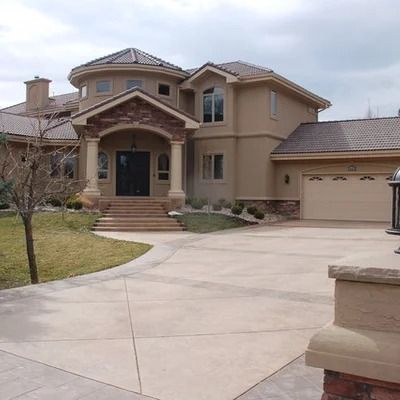 a large house with two garages in front of it