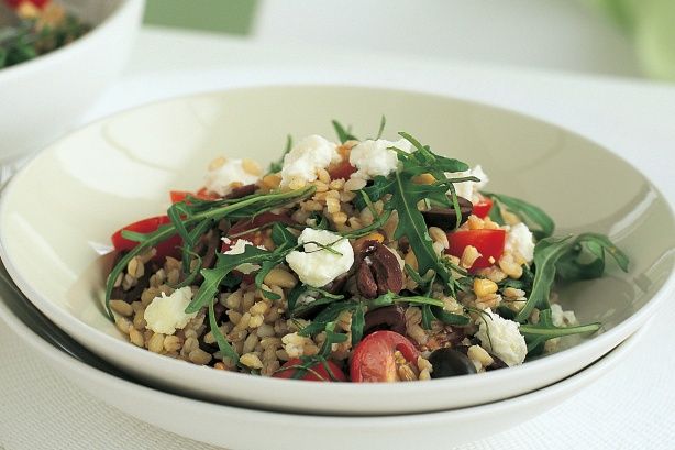 a white bowl filled with food on top of a table