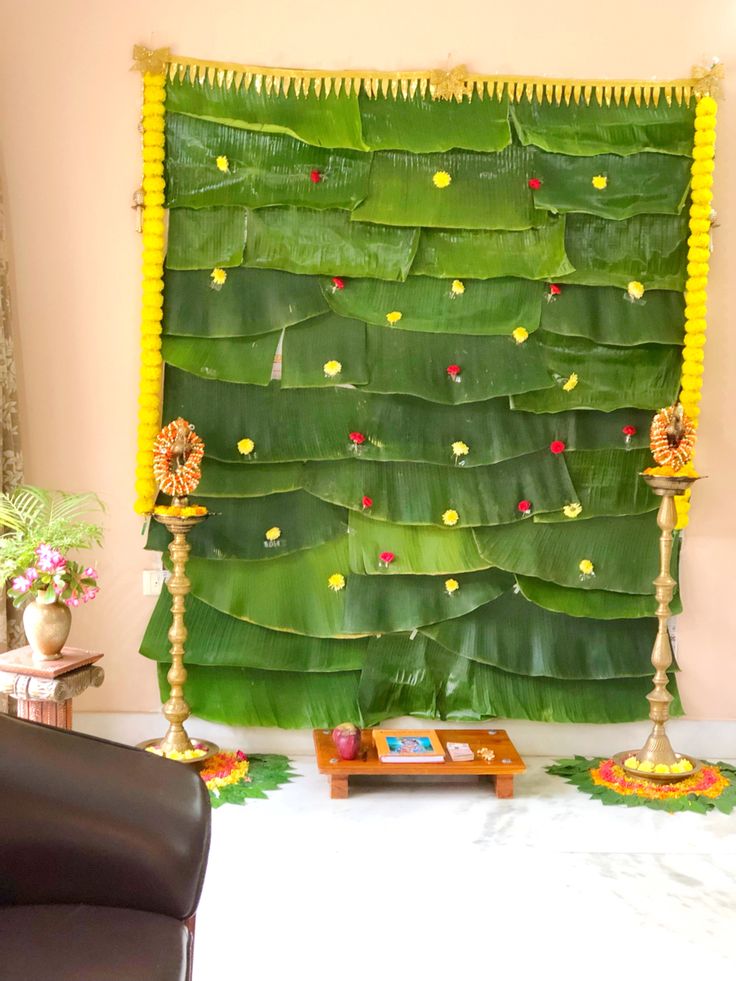 a large green wall hanging on the side of a wall next to a brown chair