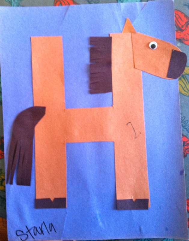 a child's handmade horse made out of construction paper on a blue background