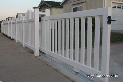 a white picket fence next to a house