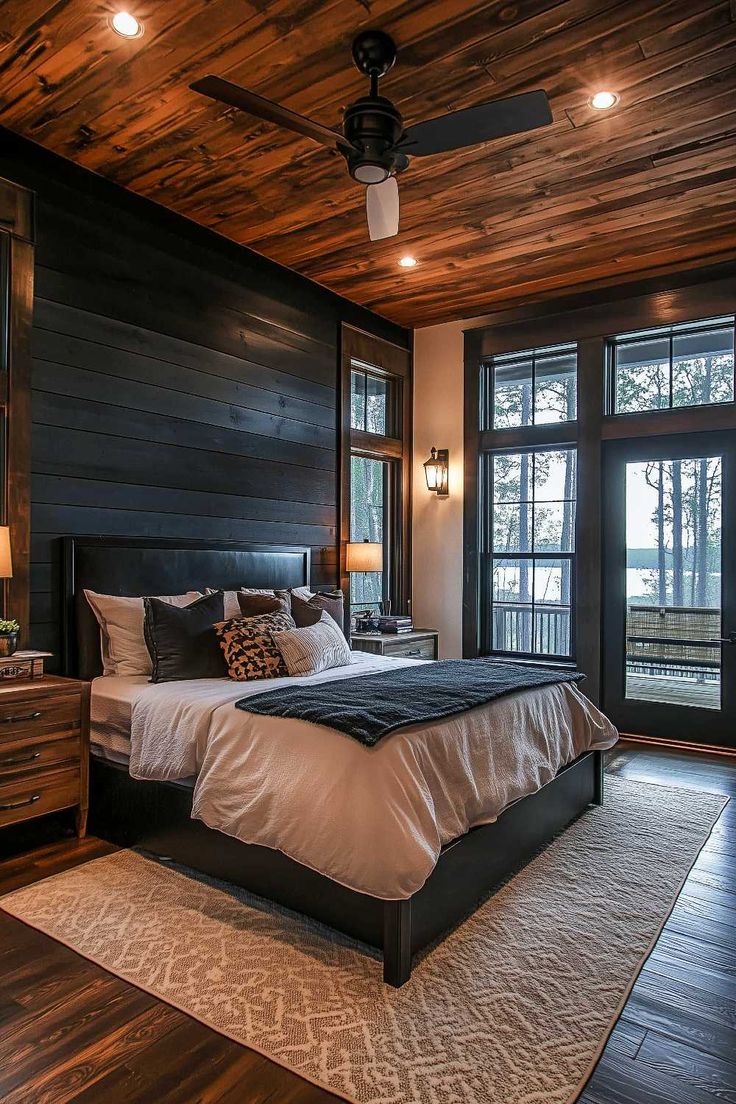 50+ Bedroom With Black Shiplap Wall Proves Black Magic Is Real Modern Farmhouse Interior Design Ideas Bedroom, Black Wall Paneling Bedroom, Headboard Between Two Windows, Shiplap Wall Black, Bedroom Wall Fireplace, Stone Wall Bedroom, Modern Industrial Bedroom Ideas, Black And Wood Bedroom, Master Bedrooms With Accent Wall