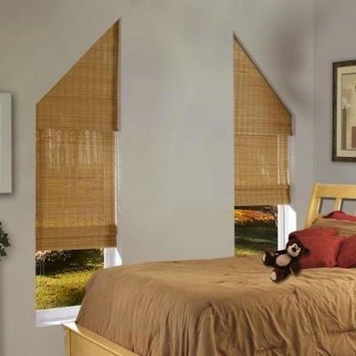 a bedroom with a bed, window blinds and pictures on the wall above it is shown