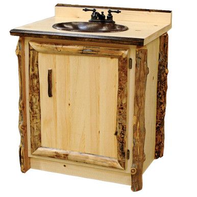 a bathroom vanity made out of wood with a sink and faucet on top