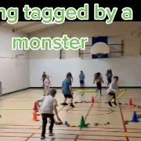 a group of children playing with toys in a gym floored area that says, being tagged by a monster