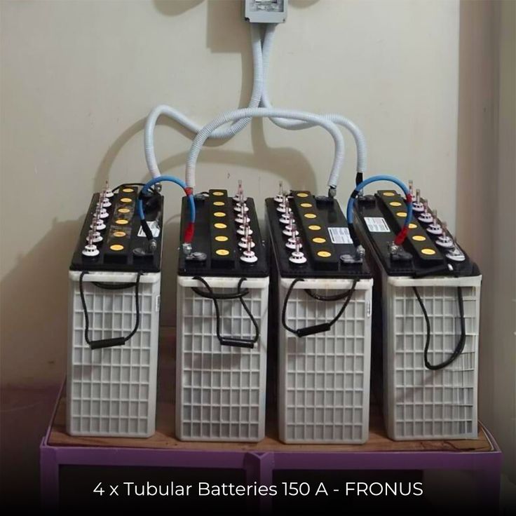 four batteries attached to the back of a wall