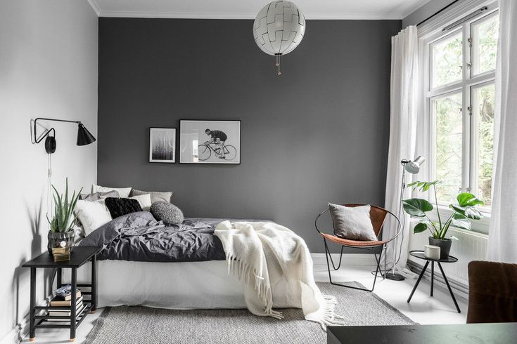 a bedroom with gray walls and white carpeted flooring in the middle of it