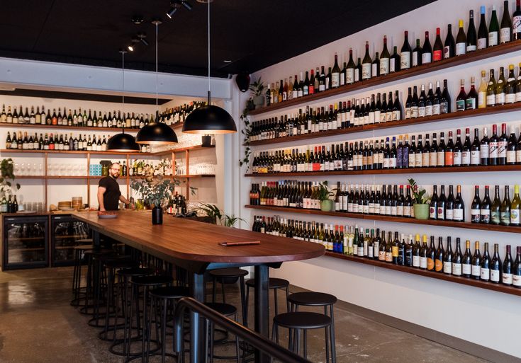 a bar with lots of bottles on the wall