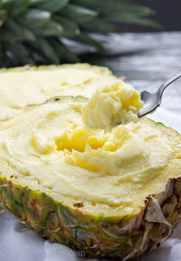 a pineapple topped with mashed potatoes and a spoon