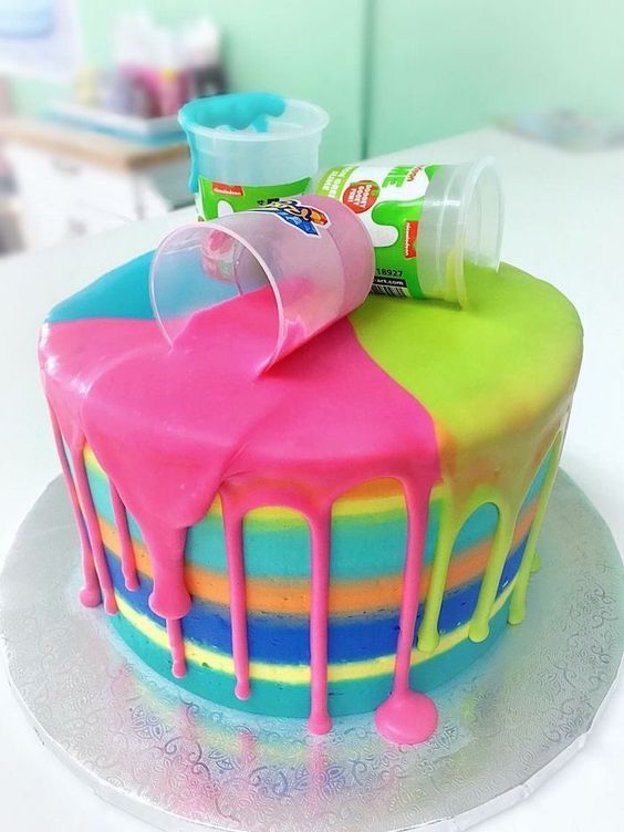 there is a colorful cake with icing on the top and some candy in the middle