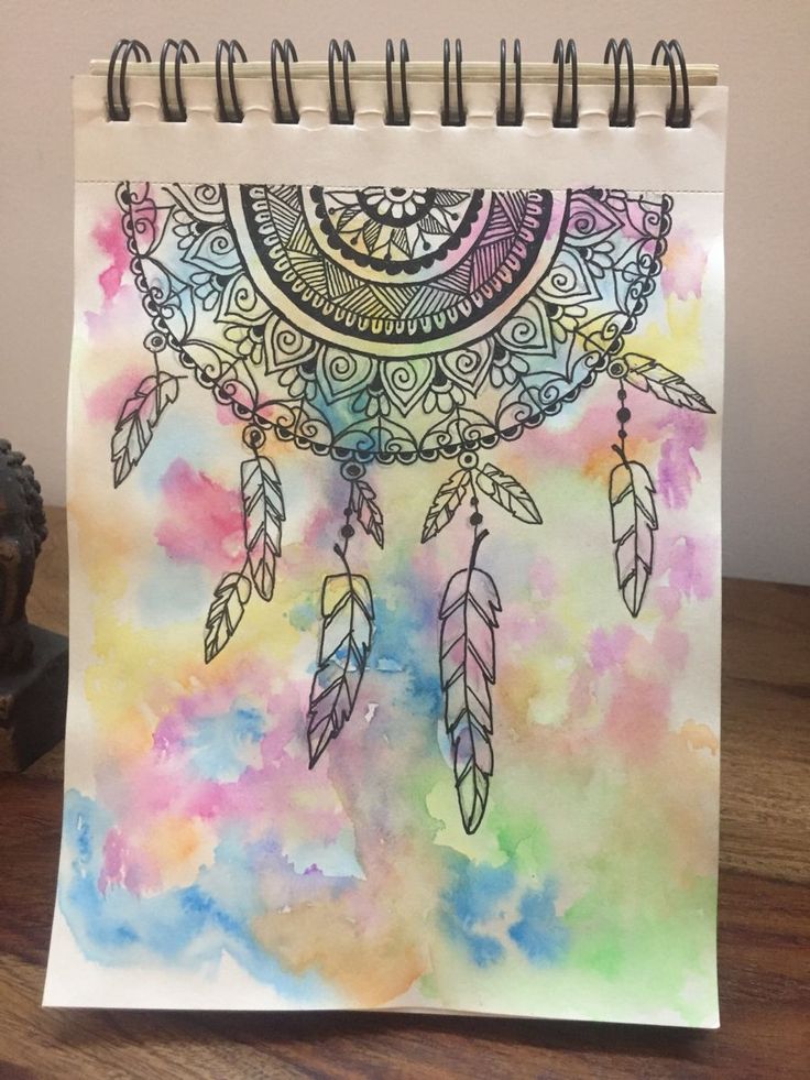 a spiral notebook with an image of a dream catcher on it