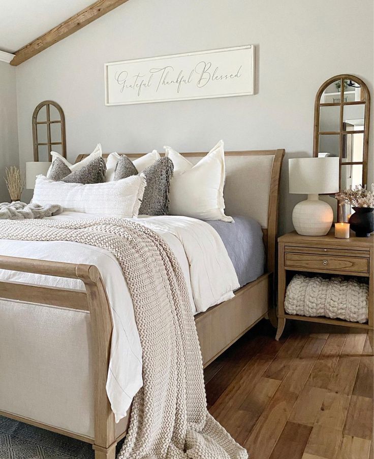 a bed with white sheets and pillows in a bedroom