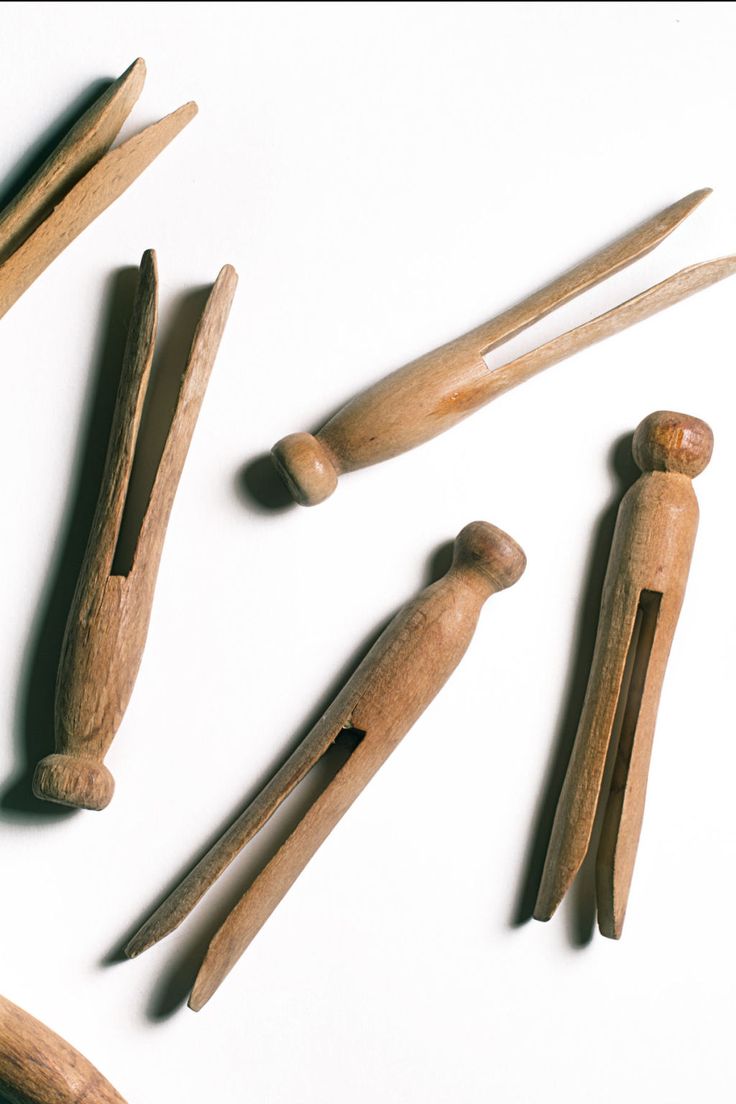 several wooden pegs are arranged on a white surface