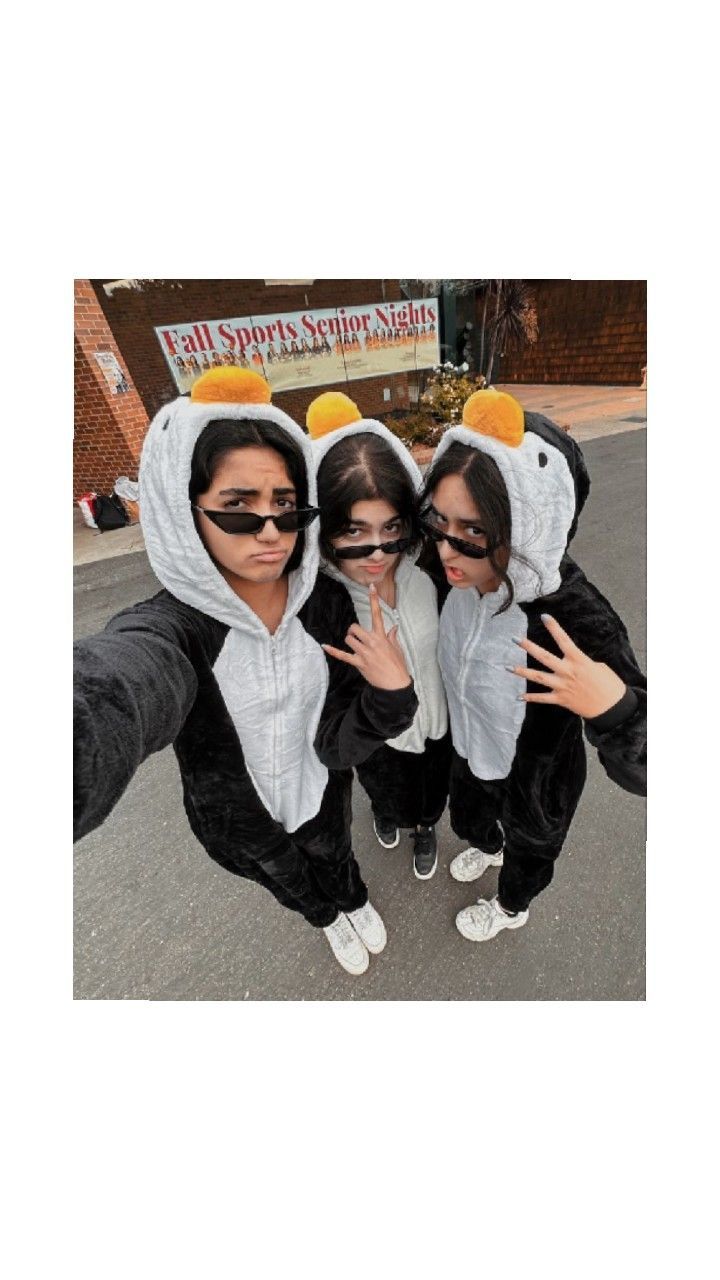 three girls in animal onesuits posing for the camera