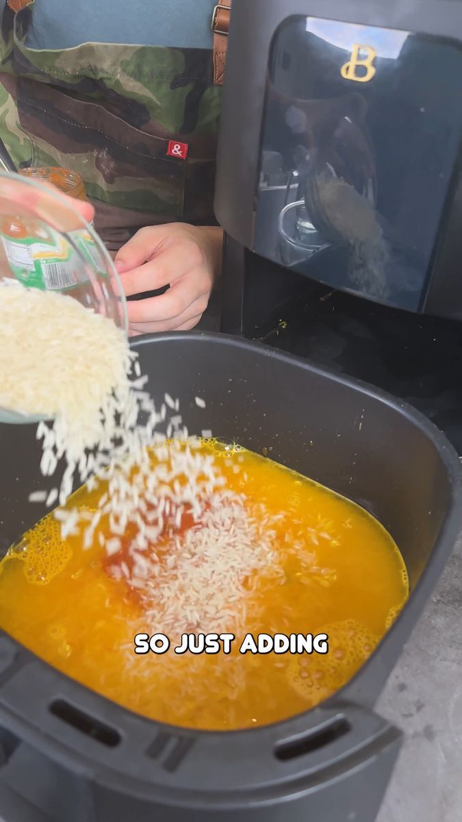 someone is adding rice to a bowl of soup