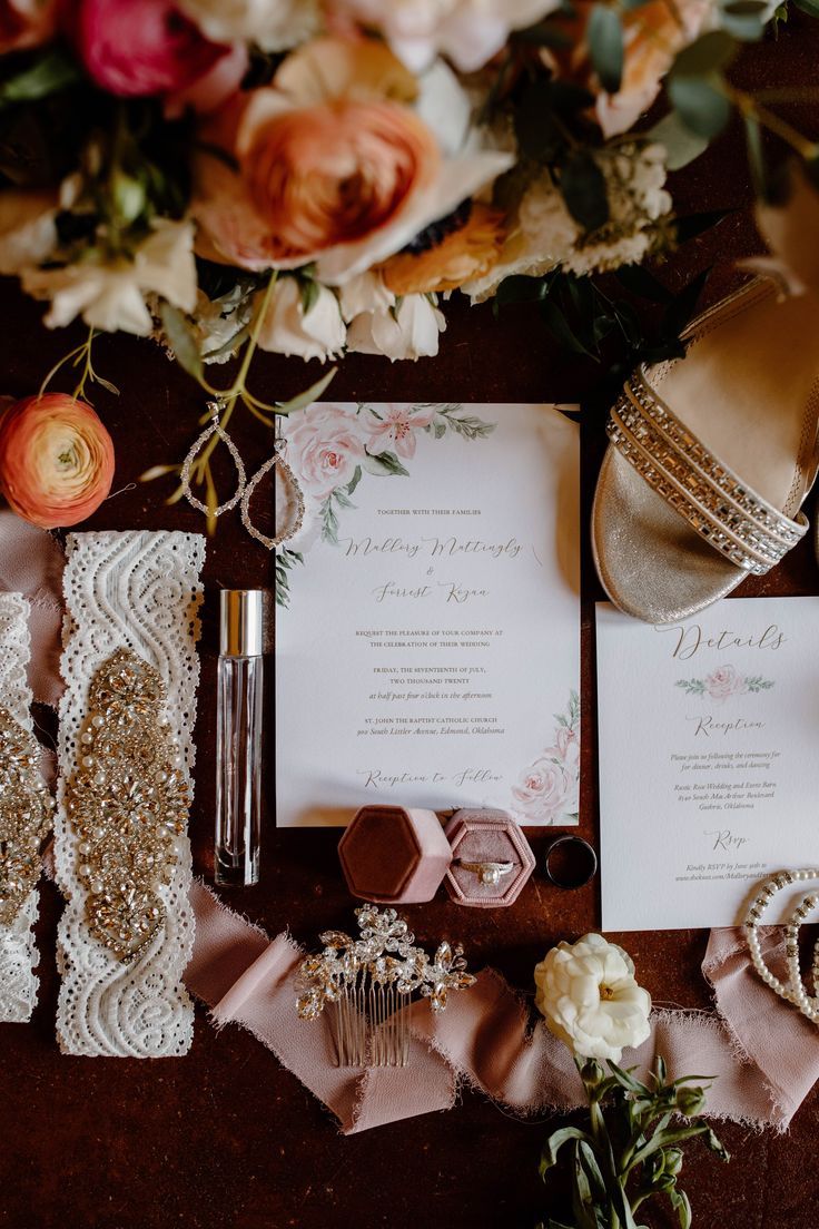 the wedding stationery is laid out on top of the table with flowers and other accessories