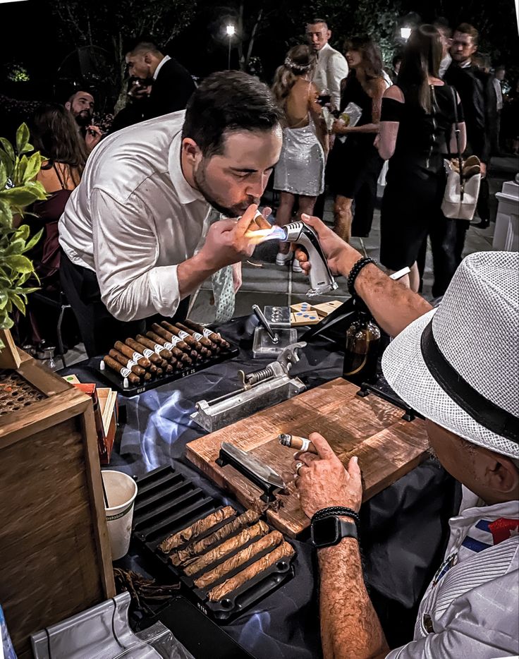 two men are sitting at a table eating food