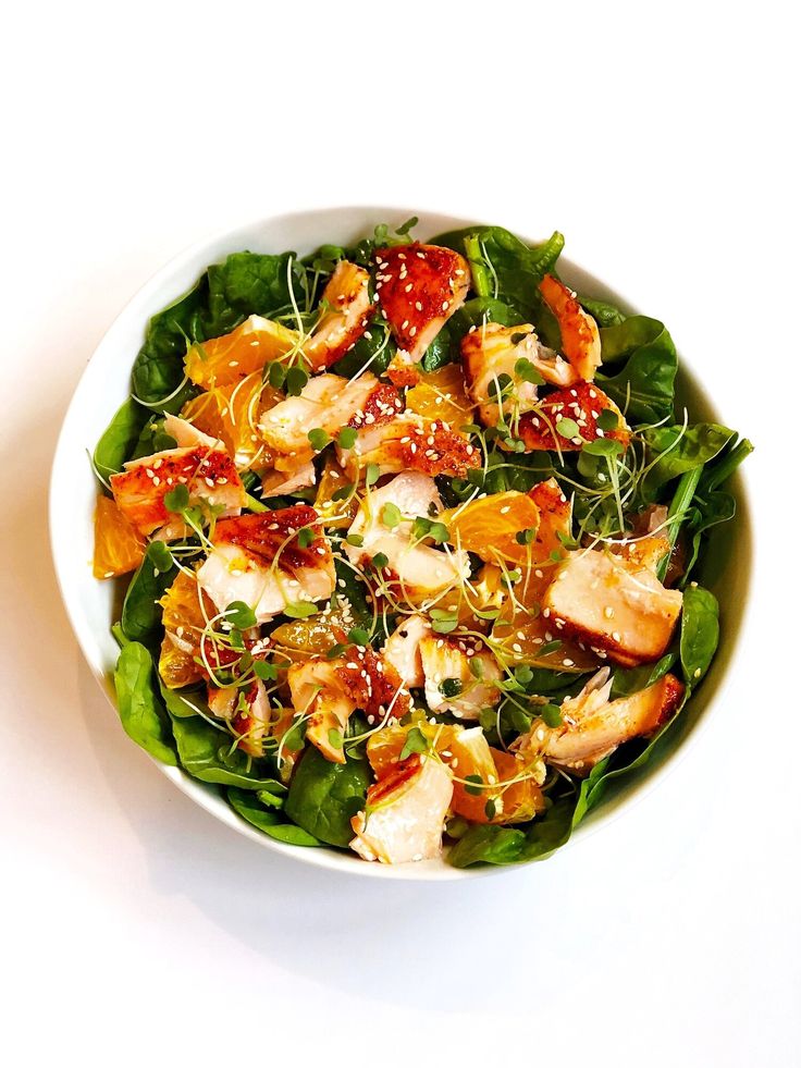 a white bowl filled with salad on top of a table