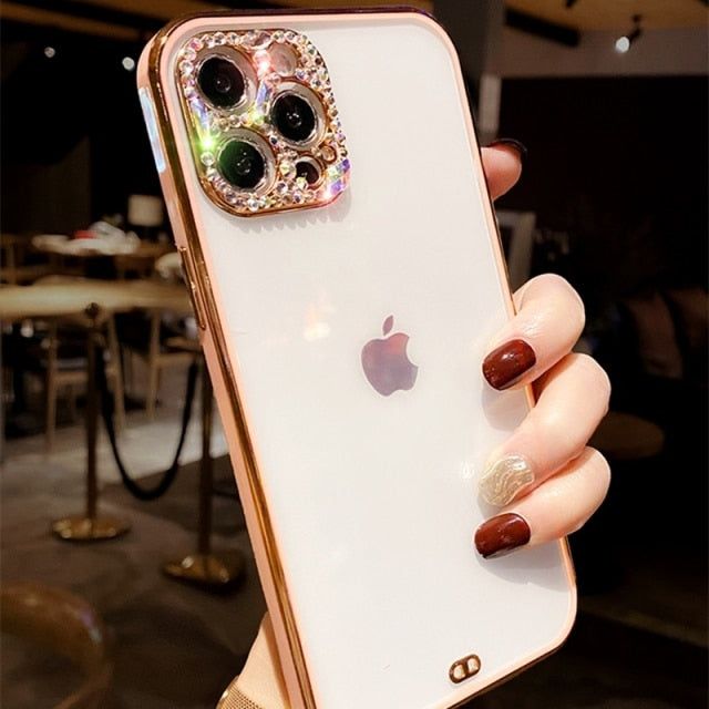 a woman holding up an iphone case with two camera lens on the back of it