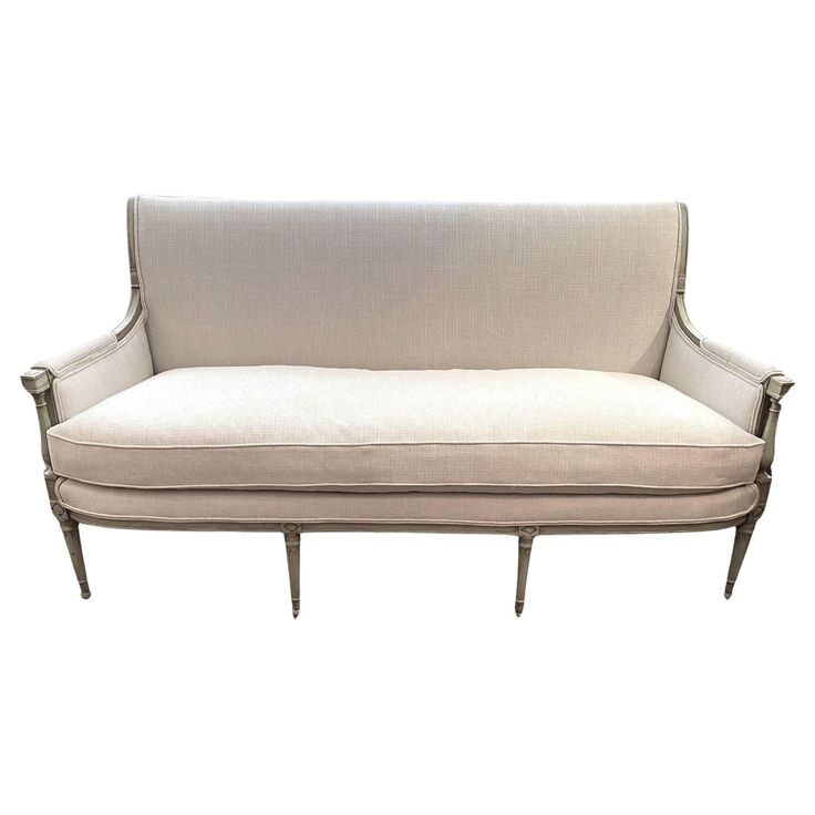 a white couch sitting on top of a wooden frame