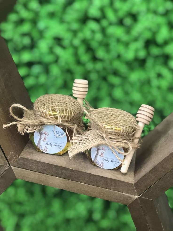 two wooden chairs sitting on top of a wooden table next to each other with tags attached to them