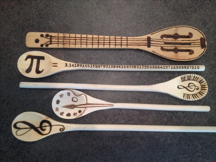 four wooden spoons with different designs on them